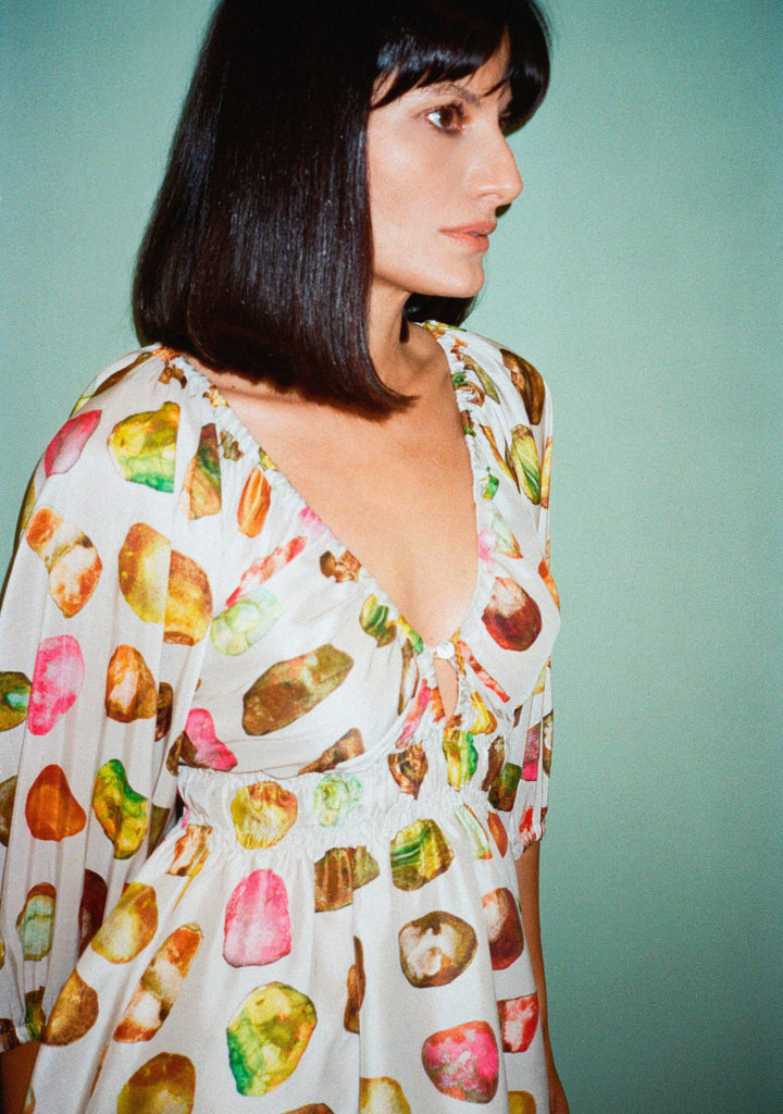 Detalhe do decote e busto do Vestido Maysa Pedraria mostrando o acabamento em seda e a estampa pintada à mão.